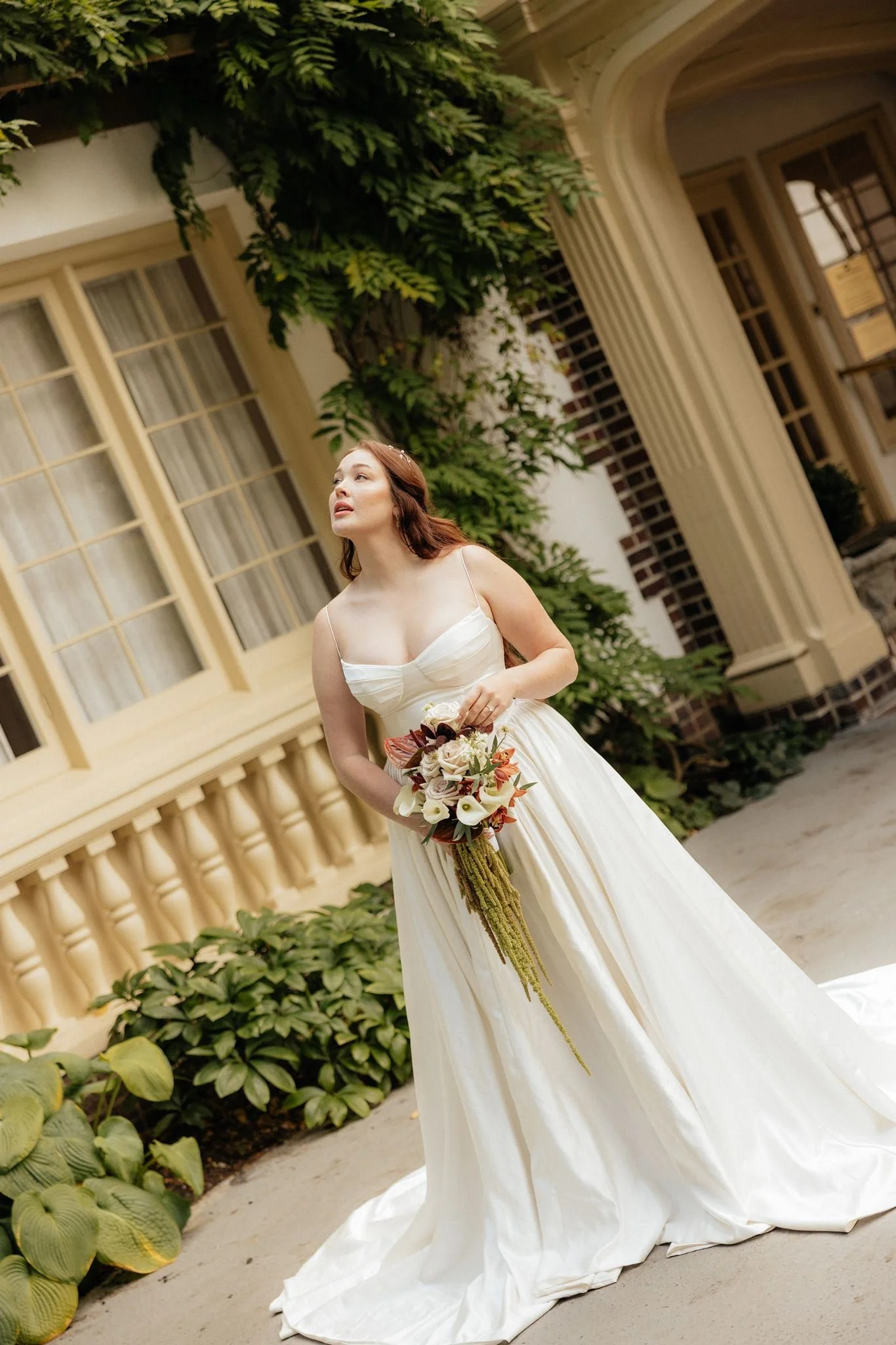 Bride at a Seattle wedding hall wedding carrying lovely white and antique red cascading bouquets by Love Letter Floral and events 