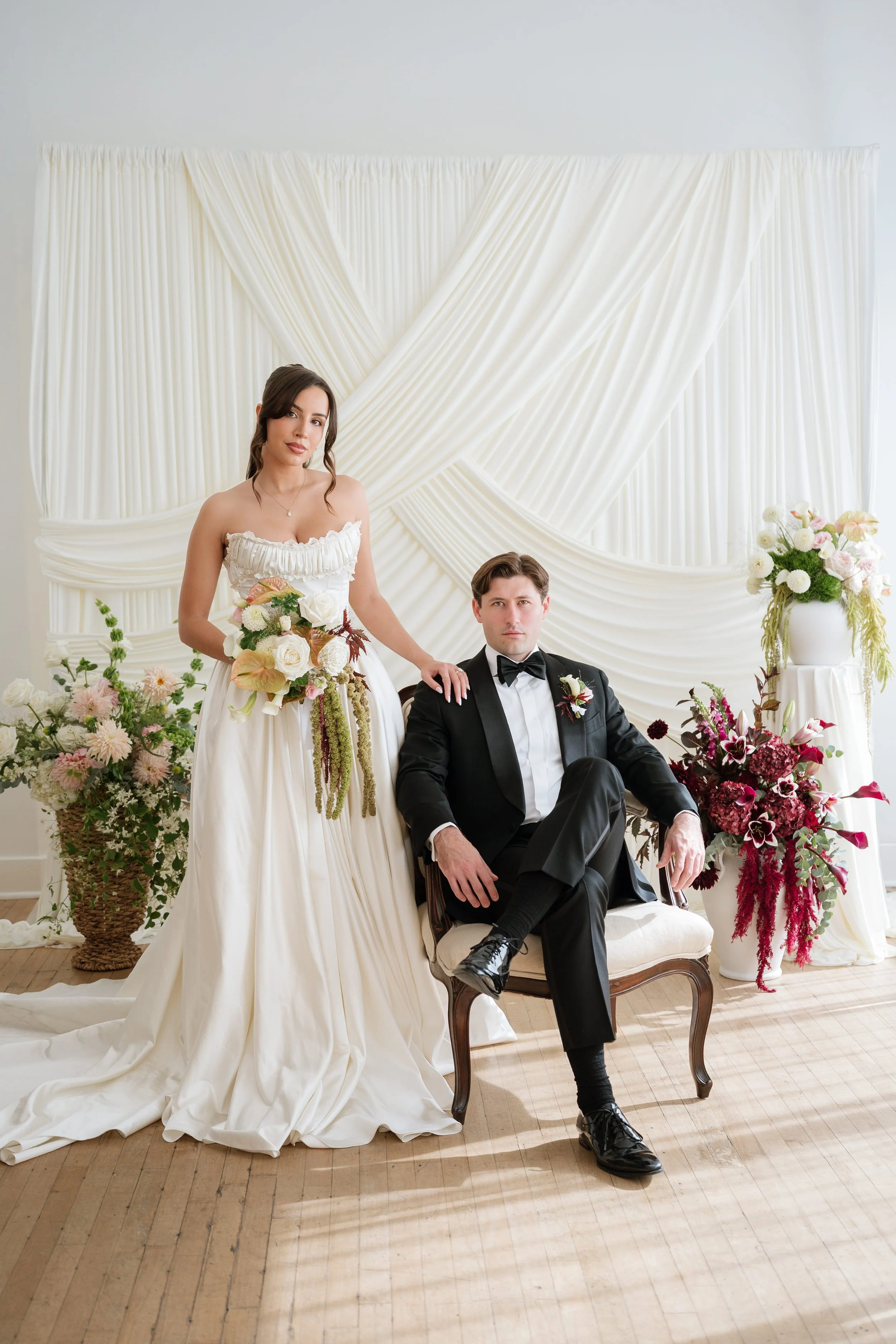 Bride and groom at Seattle wedding reception with modern blush and burgundy florals by Love Letter Florals & Events
