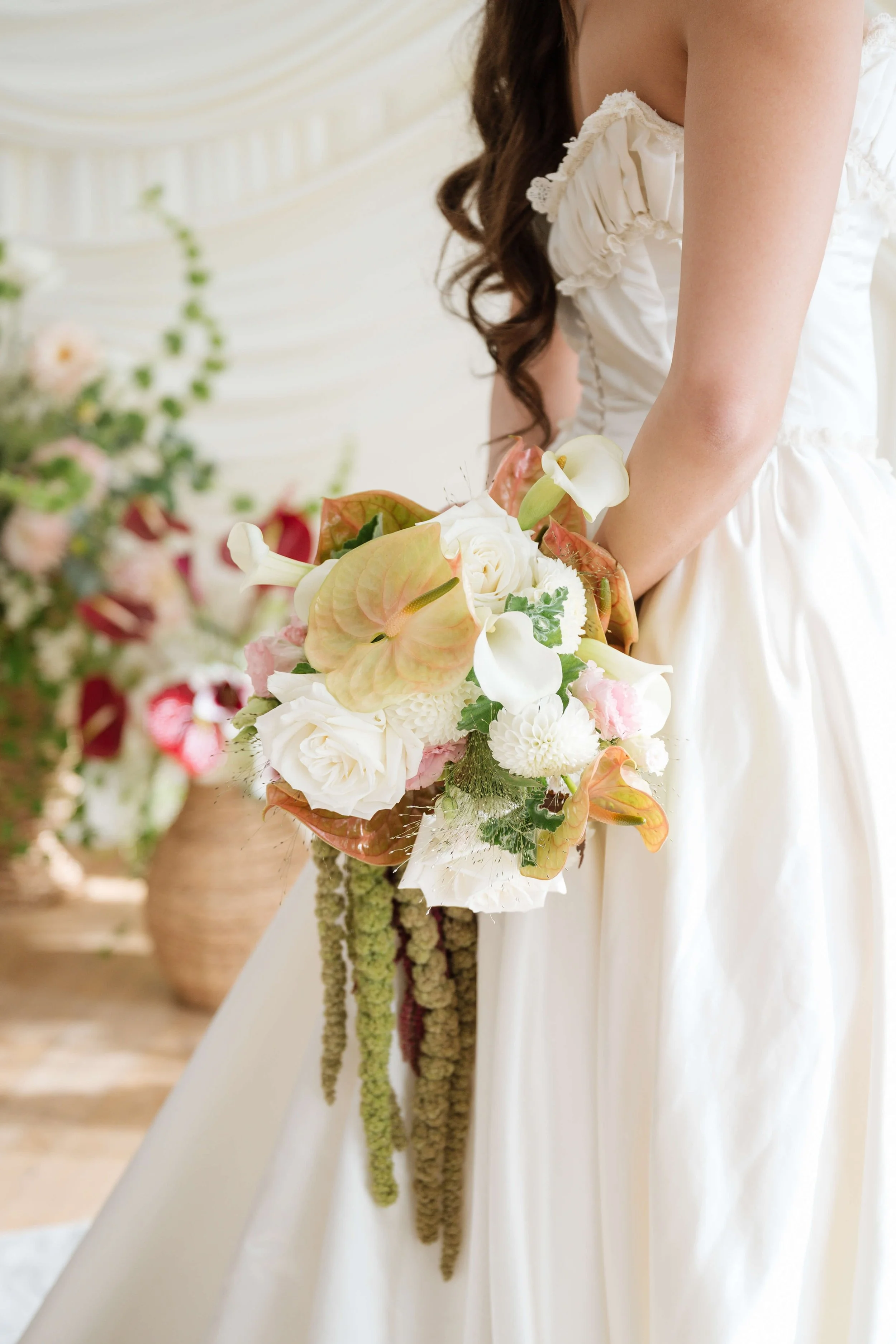 gorgeous modern bridal bouquet with blush iridescent anthurium, garden roses, calla lilies, and green hanging amaranthus by Love Letter Florals in Seattle and Tacoma