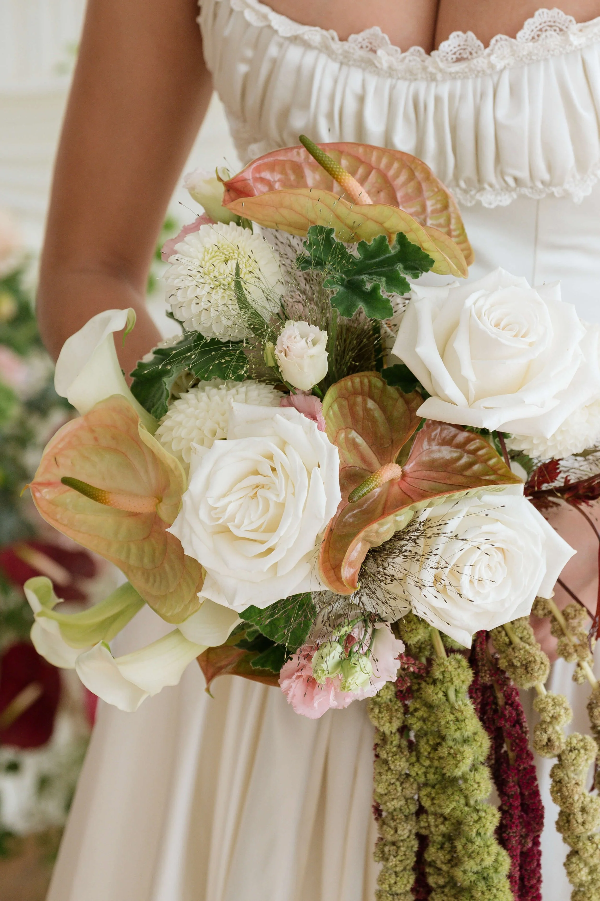 gorgeous modern bridal bouquet with blush iridescent anthurium, garden roses, calla lilies, and green hanging amaranthus by Love Letter Florals in Seattle and Tacoma