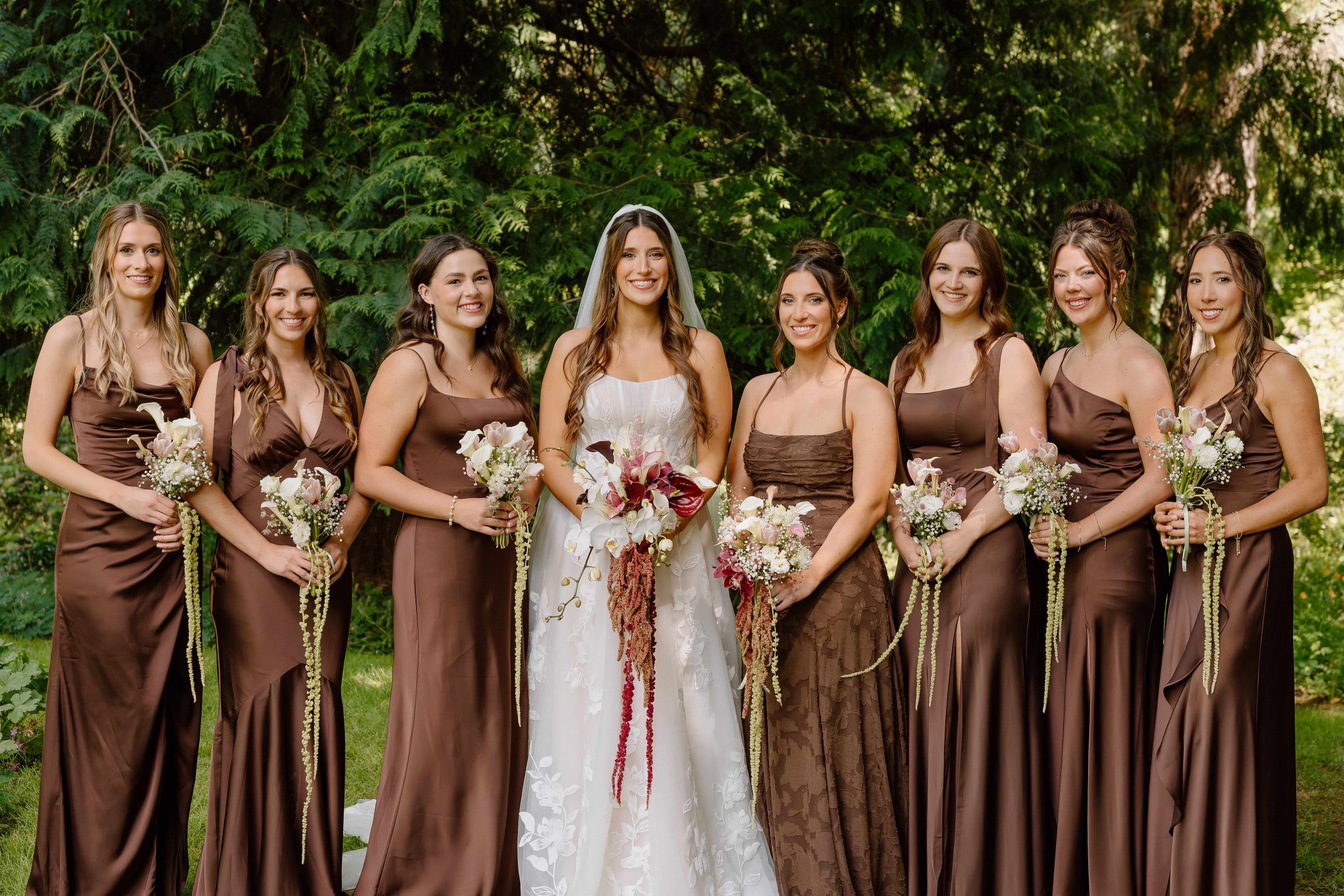 Bride and Bridal Party at a Pacific Northwest wedding carrying lovely green white and antique red cascading bouquets by Love Letter