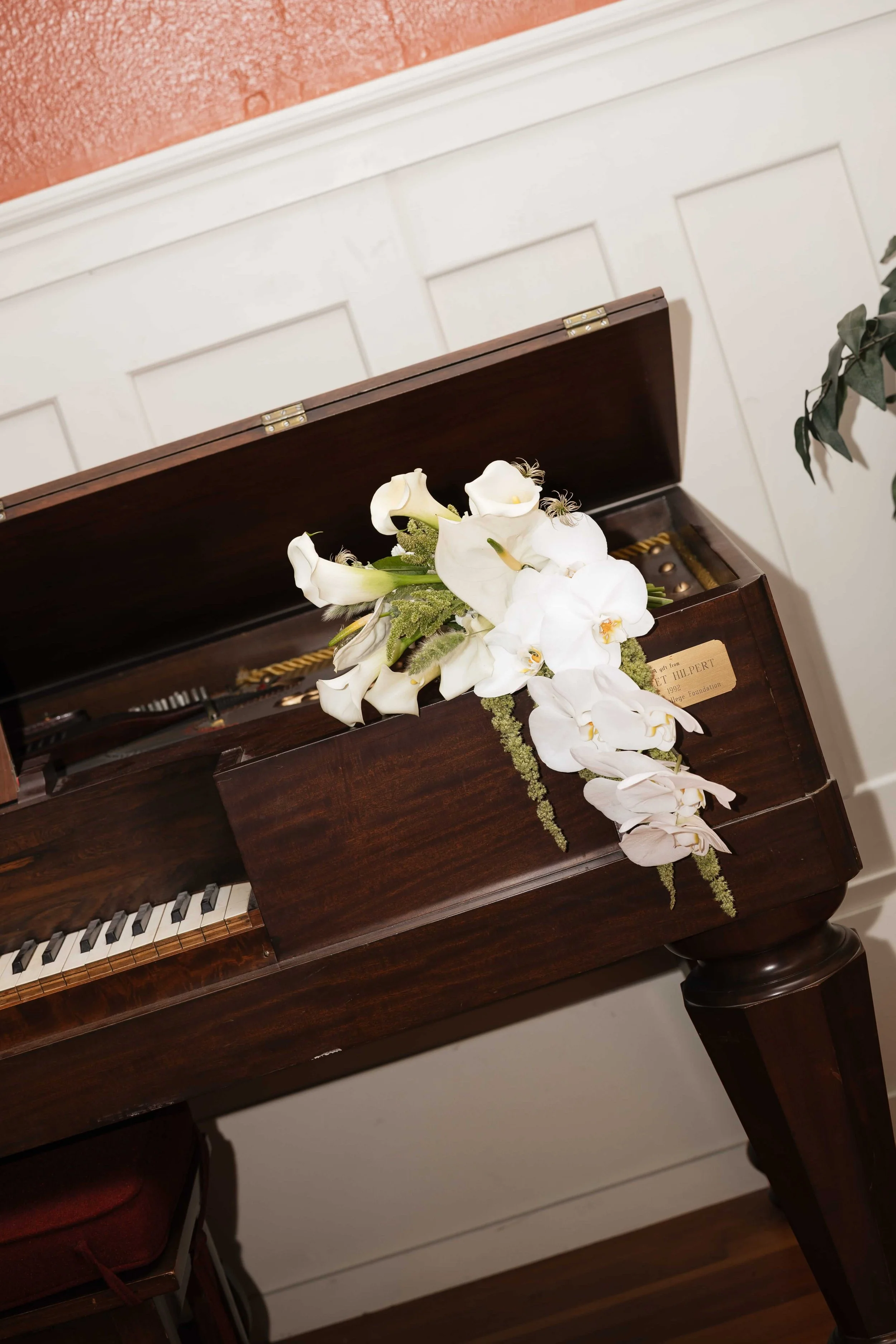 Green and white orchid cascading bouquet by Love Letter Floral & Events is a Seattle Washington