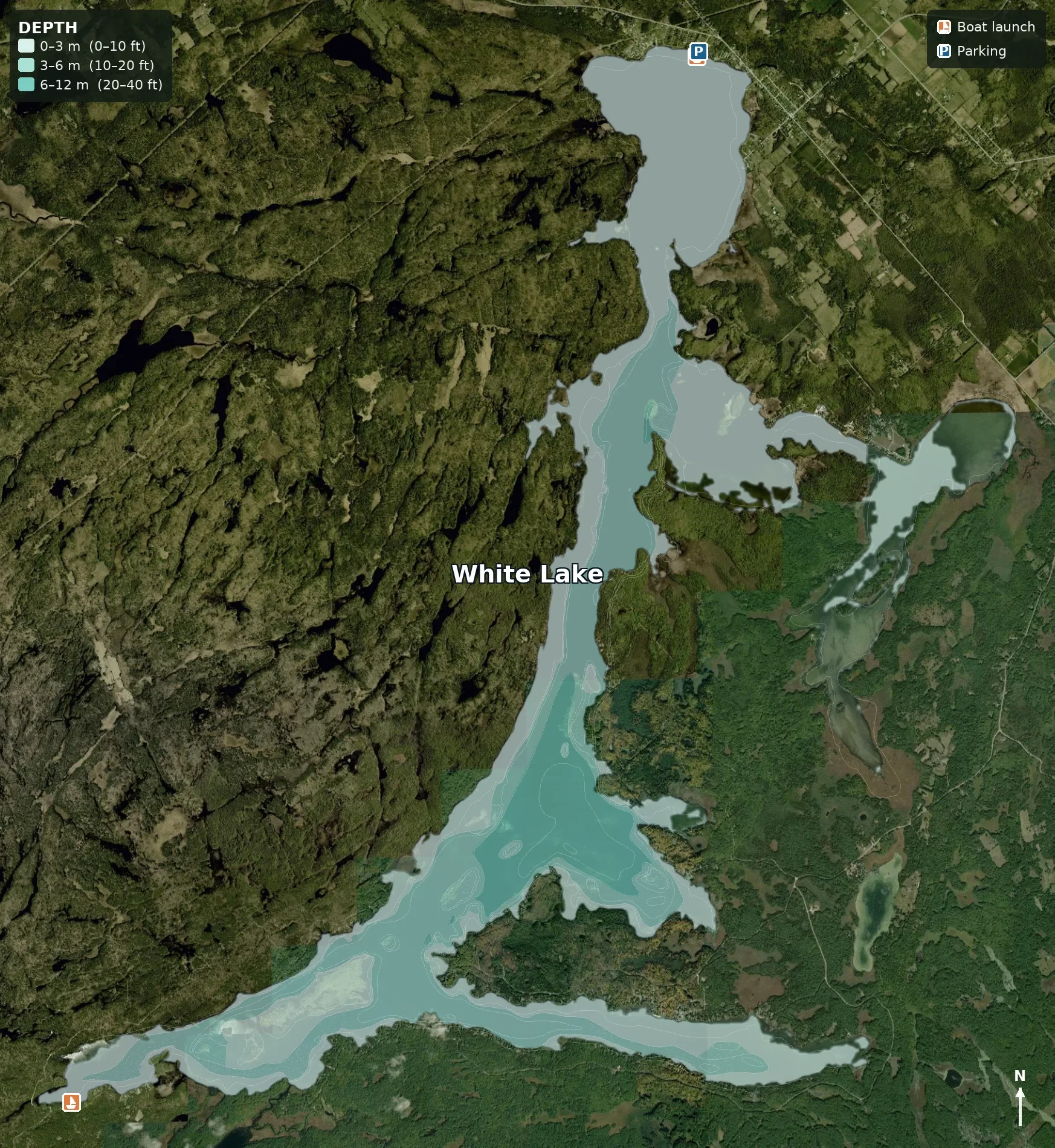 Map of White Lake showing depths, boat launch, and parking areas. The lake is surrounded by dense forest and some roads, with a small town to the northeast.