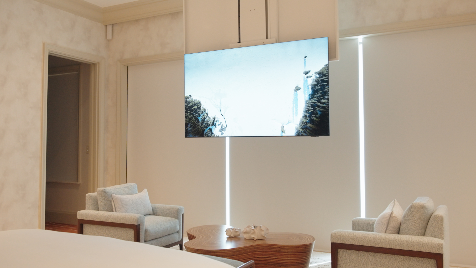 Television descending from a concealed ceiling lift, invisible in the room when it's down