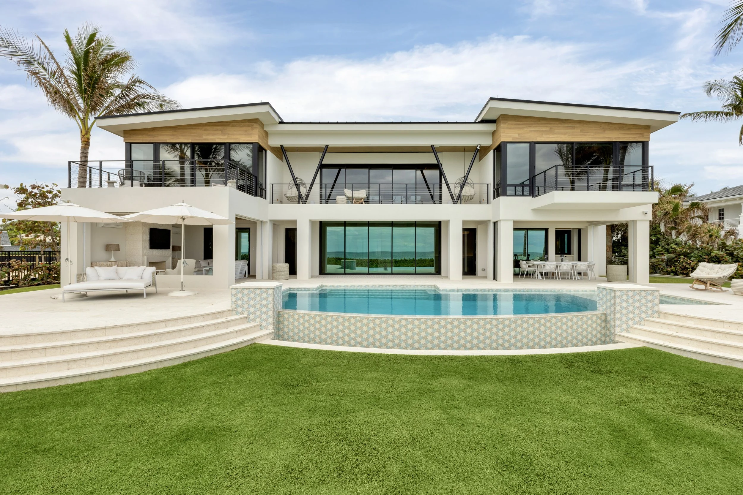 Rear elevation and pool of a contemporary oceanfront home in Jupiter, Florida