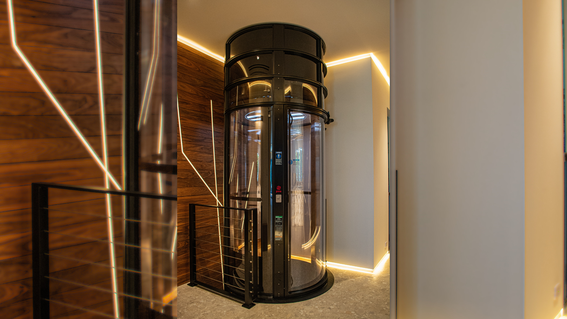 The glass elevator whose shaft set the fixed boundary of the theater envelope