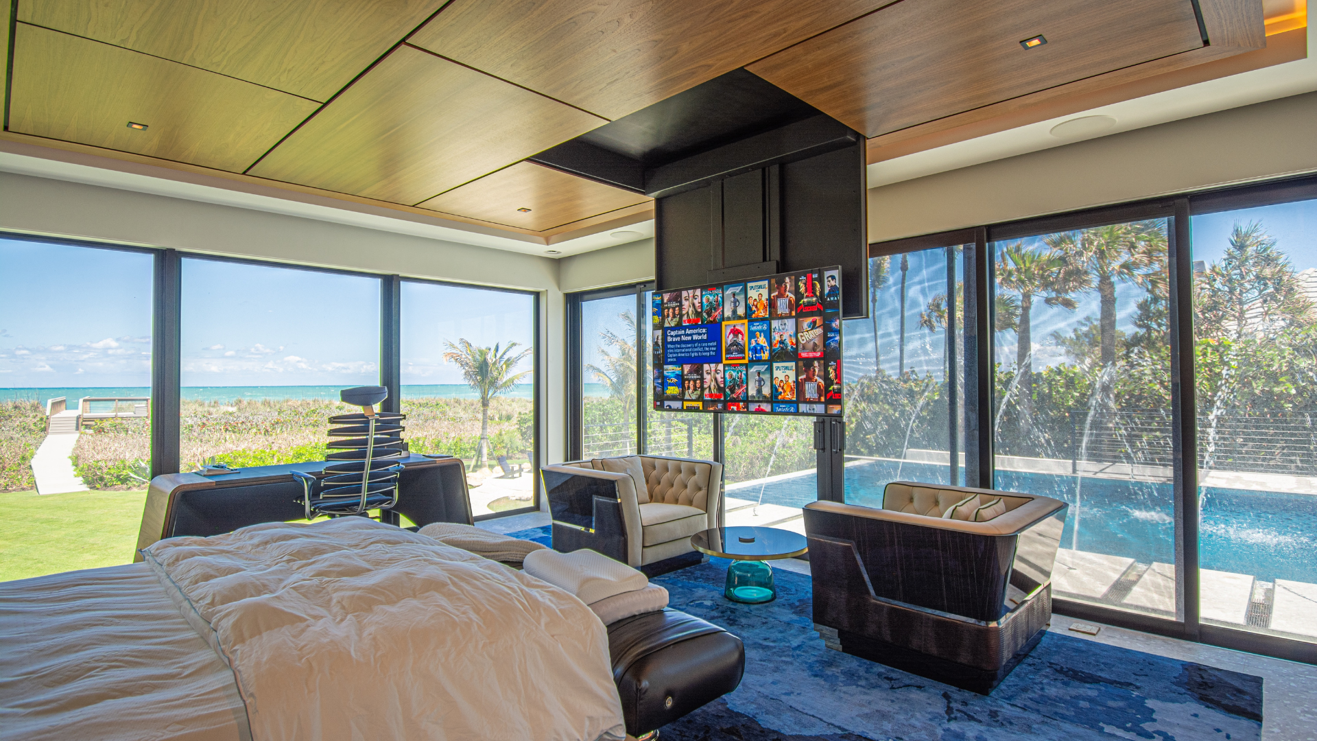 Television lowering from a wood ceiling in an oceanfront bedroom, Hobe Sound