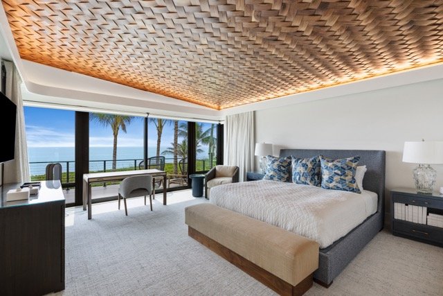 Cove lighting above a woven ceiling in an oceanfront primary suite, Jupiter, Florida