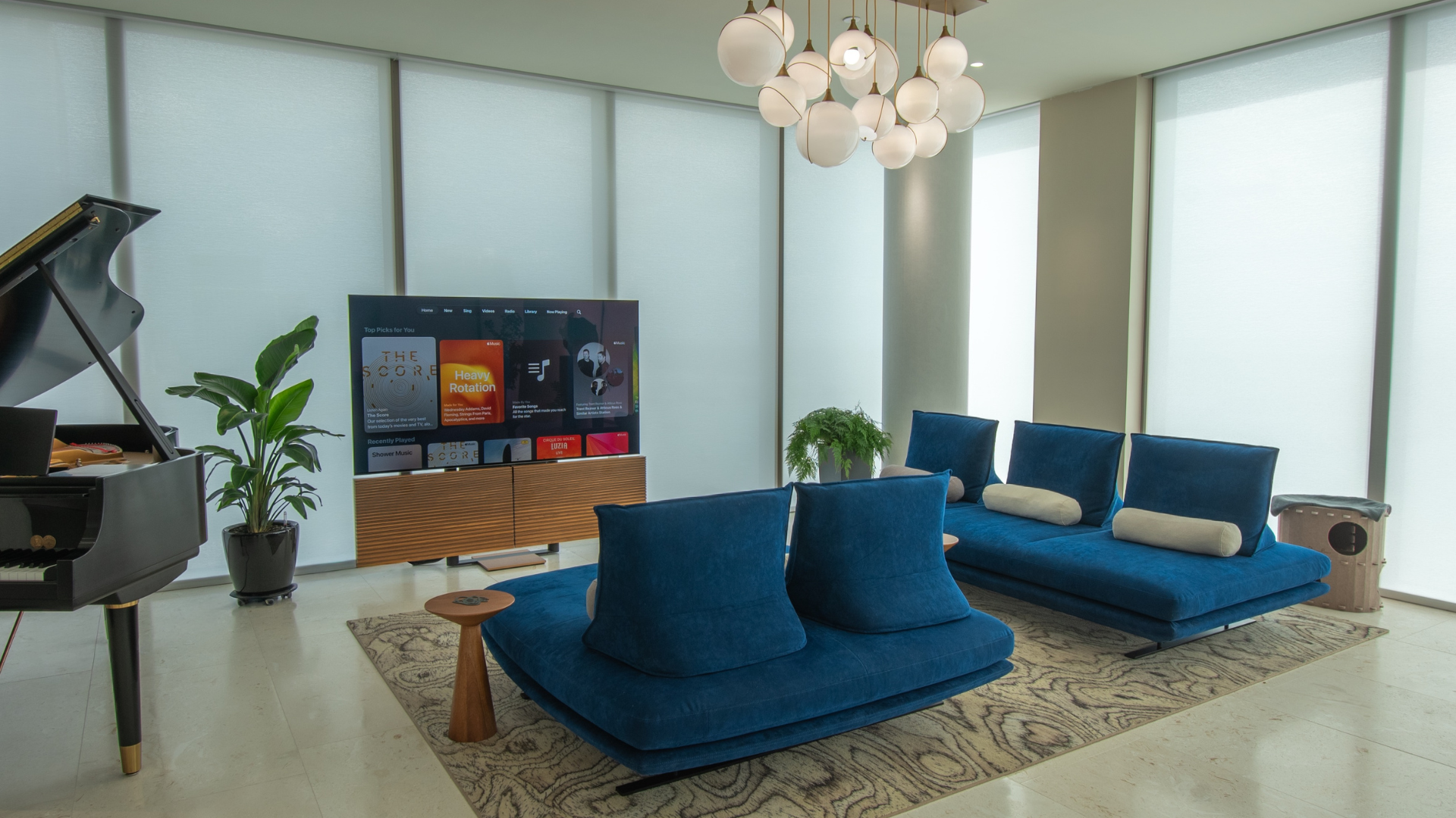 Living room with shades lowered against afternoon glare, light softened rather than shut out