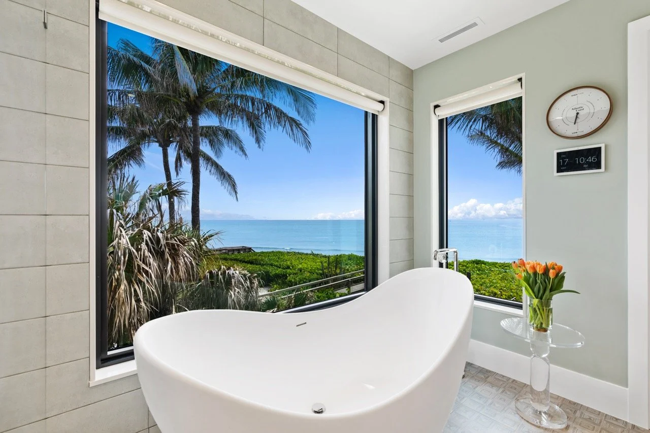 Primary bathroom with concealed lighting in an oceanfront Jupiter residence