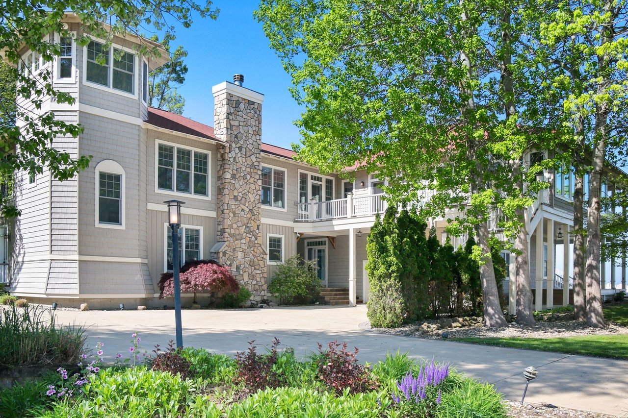 Haven House is a large three-story house with a wrap-around porch and staircase on the waters of Lake Michigan. 