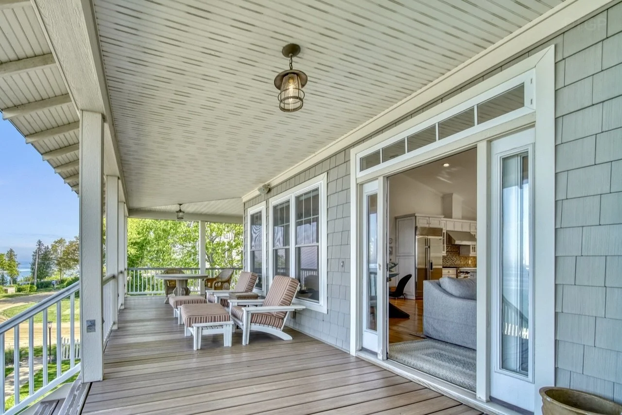 Spacious covered porch with outdoor seating. 
