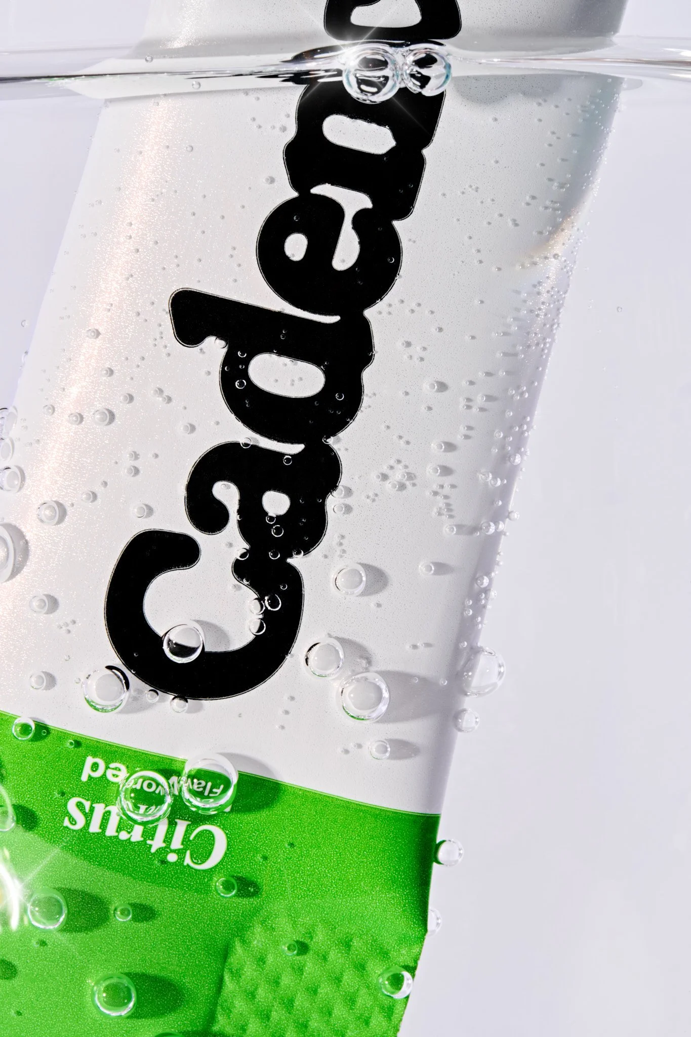 Macro creative product photography shot of a Cadence electrolyte drink powder sachet. 