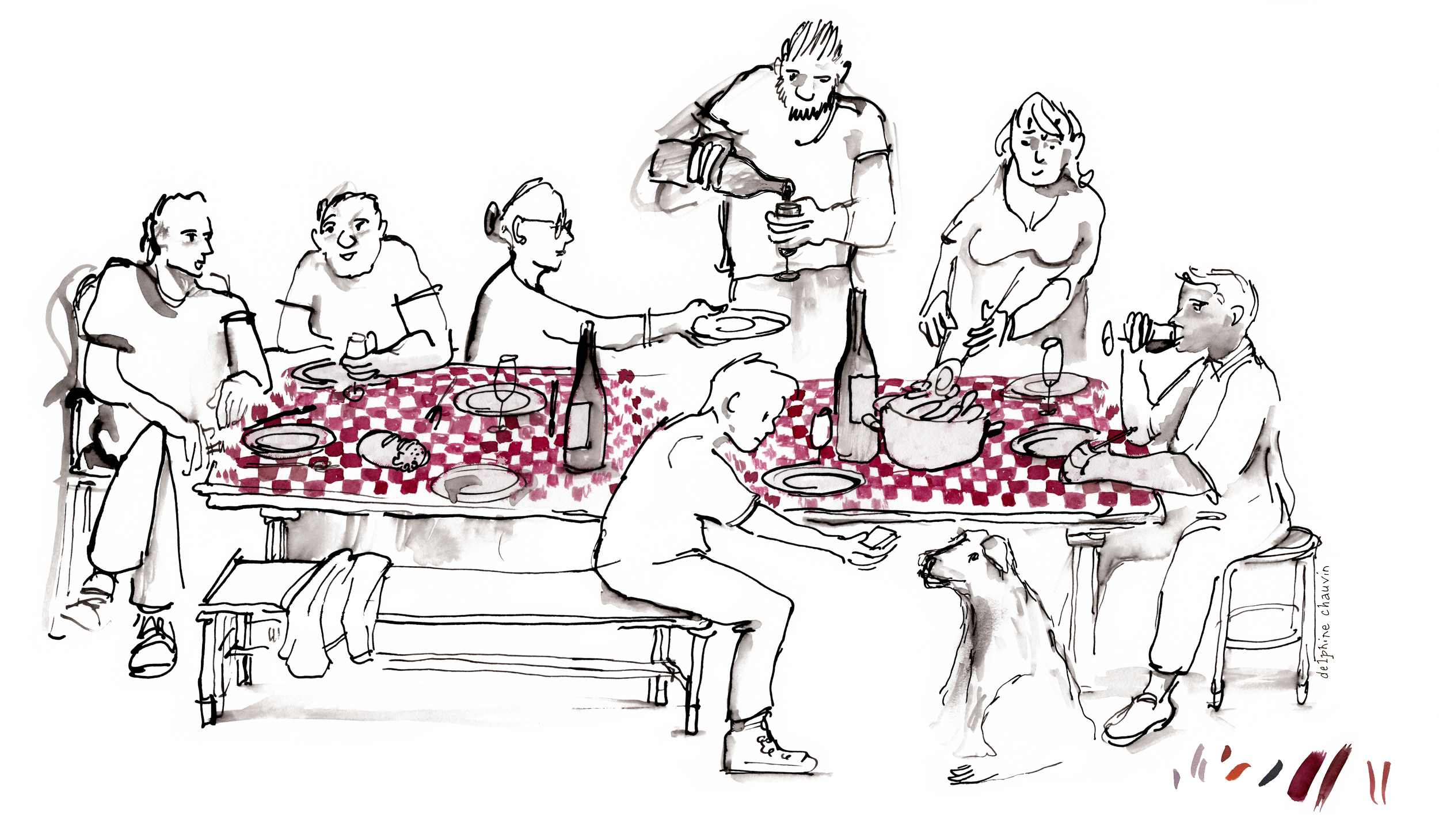 En gruppe mennesker sidder omkring et langbord med rødt og hvidt ternet duge. Nogle drikker vin, en mand hælder vin i et glas, og der er en hund ved fødderne på en af personerne.