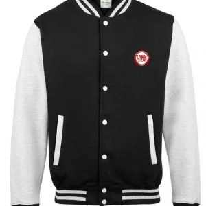 Black and white varsity jacket with white sleeves, black body, and snap buttons, featuring a circular patch on the chest.