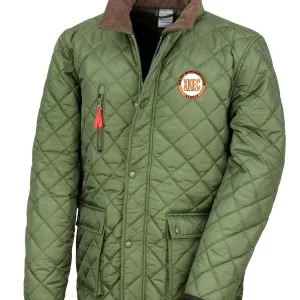 A person wearing a green quilted jacket with a brown collar and a patch on the chest that reads 'UKFC'.