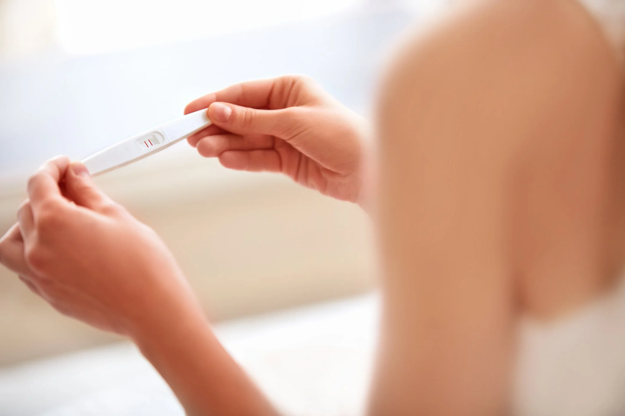 Woman looking at Pregnancy Test