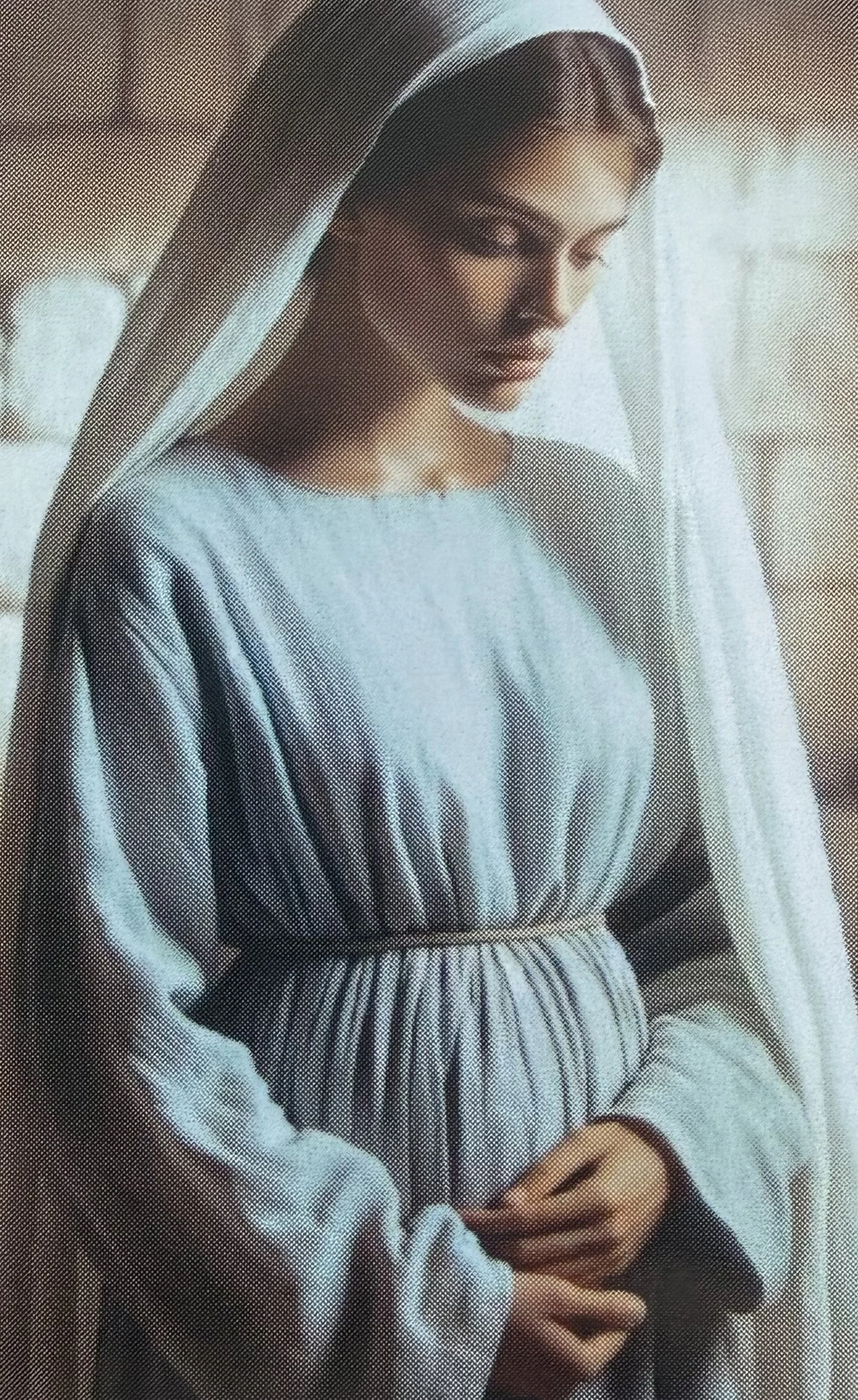Religious painting of the Virgin Mary with a contemplative expression, wearing a blue robe and veil, with hands clasped.