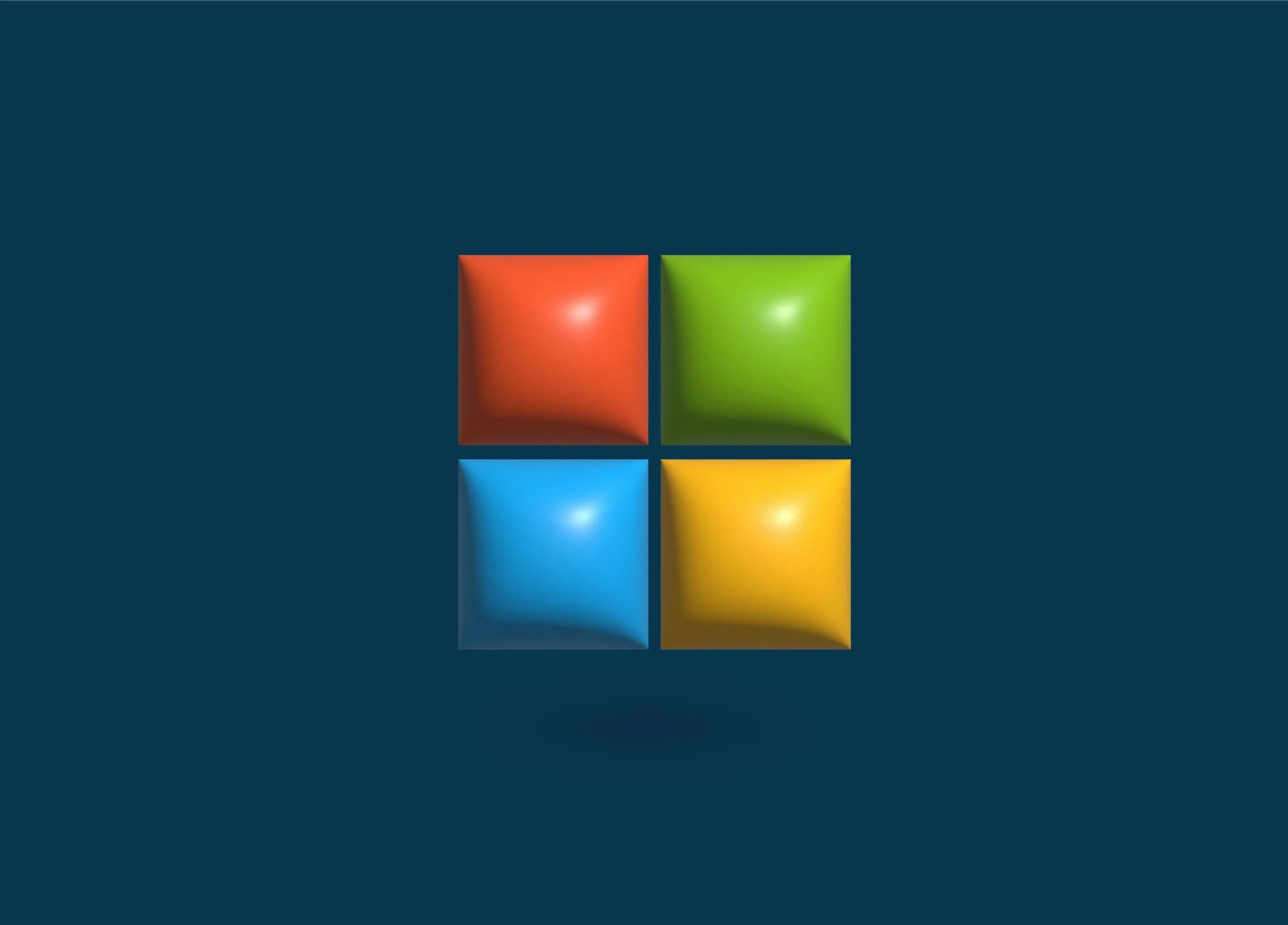 Four colorful 3D cubes of red, green, blue, and yellow arranged on a dark blue background.