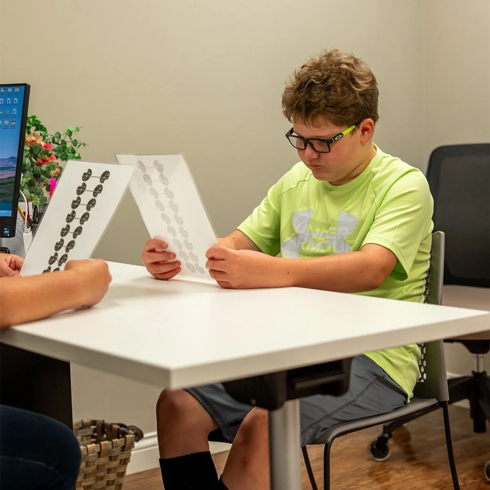 Boy Reading During Visual Motor Therapy | Vision Development Center