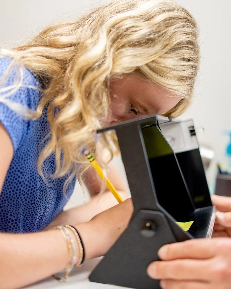 Girl looking through vision tool | Vision Development Center