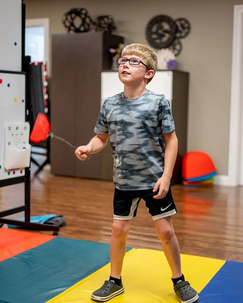 Boy performing Visual Motor Therapy | Visual Development Center
