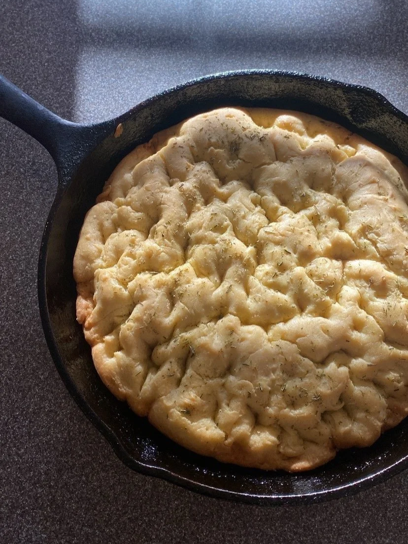 Gluten Free focaccia bread in a cast iron pan.