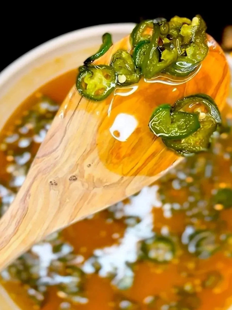 Spoonful of spicy jalapeño peppers in honey