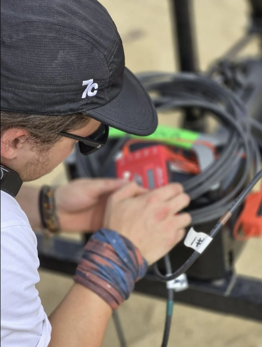 7C technician in a 7C cap preparing cables