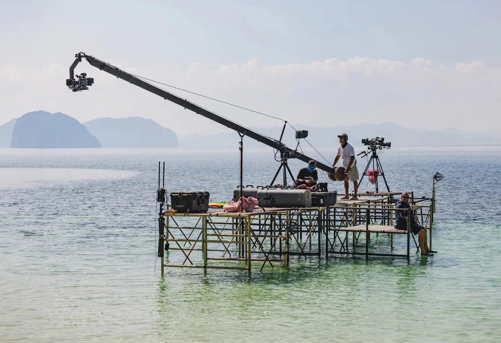7C crew operating a camera crane from a platform built in the sea