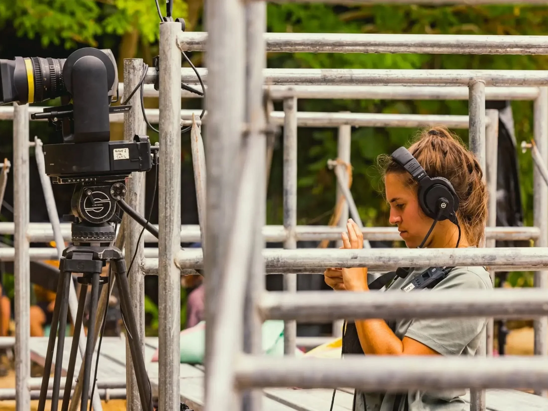 Technician with headphones behind scaffolding