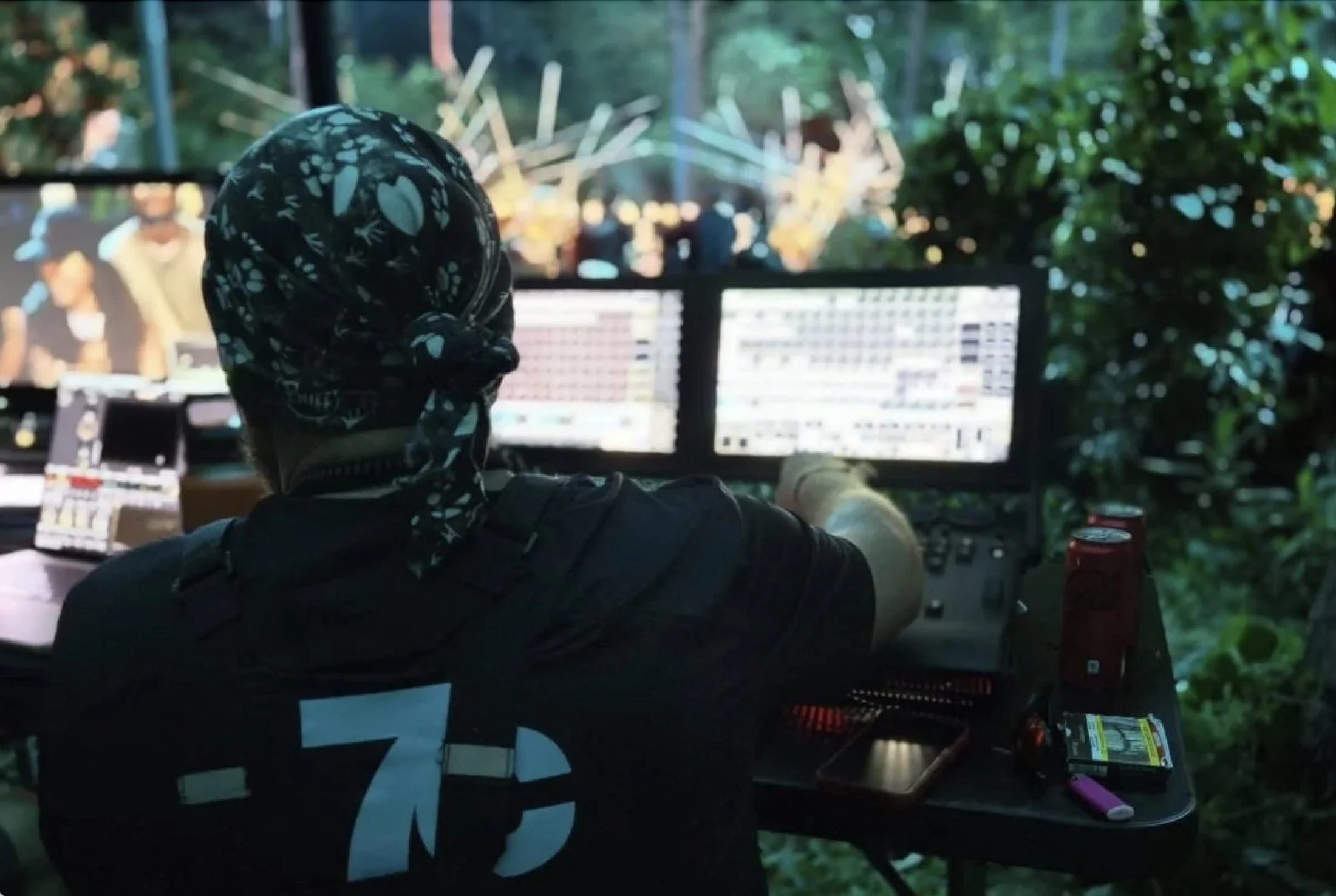 7C technician at a lighting console, seen from behind