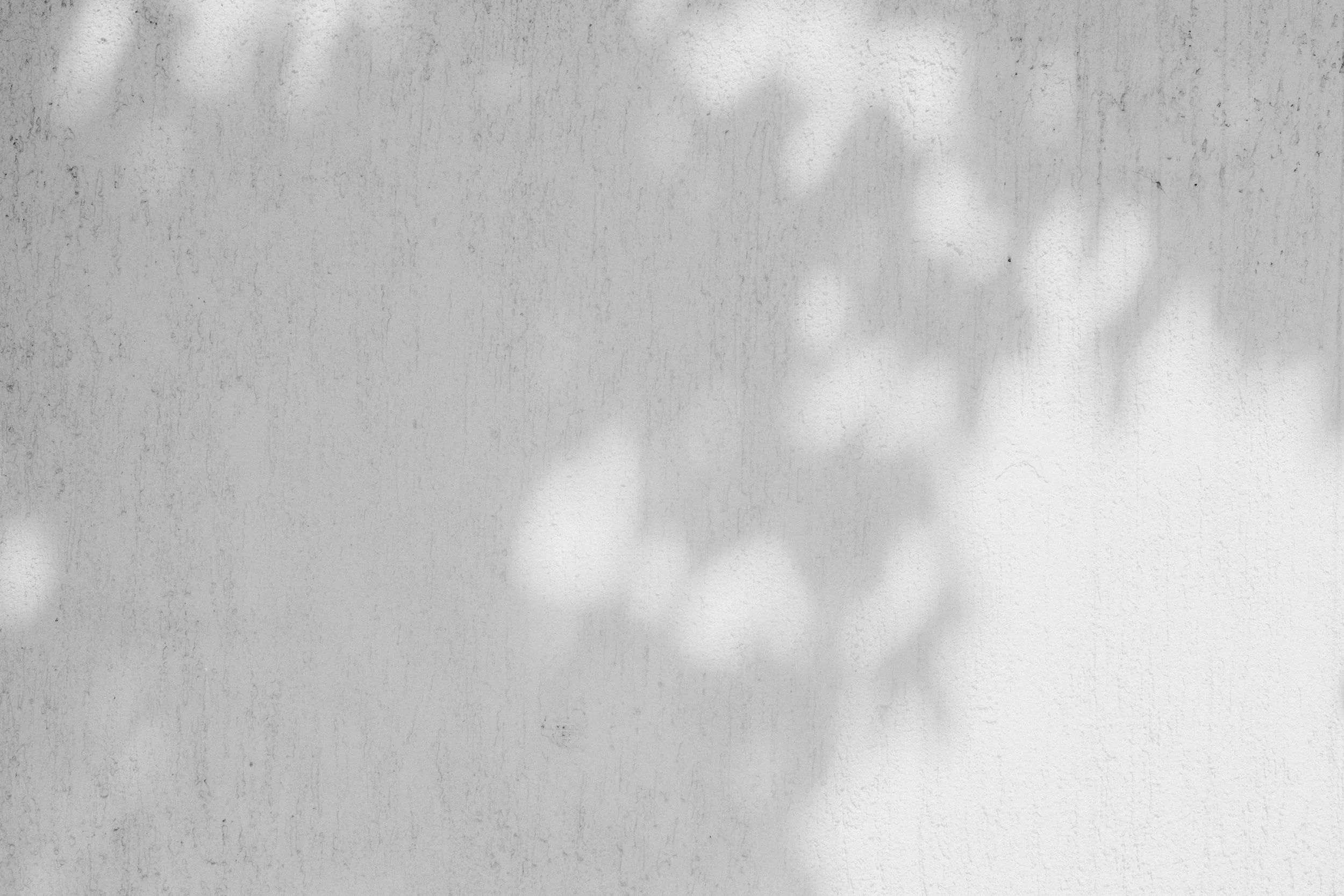 A textured metal surface with faint streaks and spots.
