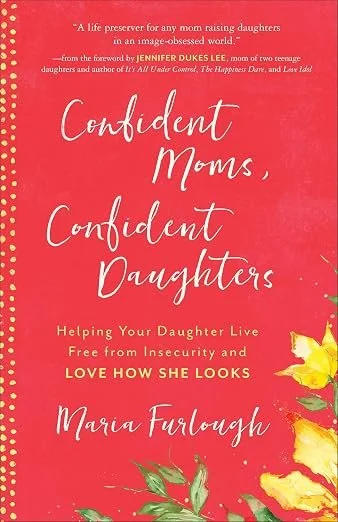 Book cover titled "Confident Moms, Confident Daughters" by Maria Furlough. The background is pink with yellow flowers and green leaves at the bottom. The subtitle reads "Helping Your Daughter Live Free from Insecurity and Love How She Looks."
