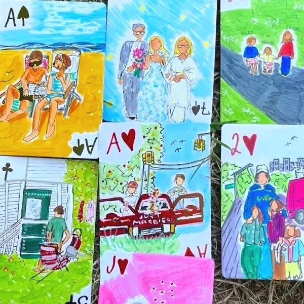 Colorful artwork depicting scenes including children at the beach, a wedding, people walking, and a family by a house. Also features playing cards with hearts and spades symbols.