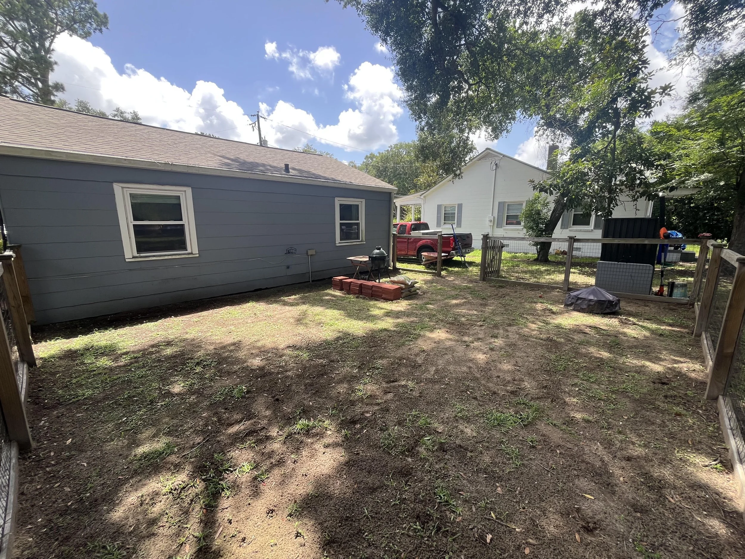 Fenced in backyard on James Island, SC prior to Biophilic landscape installation. Virtually no vegetation or outdoor living space.