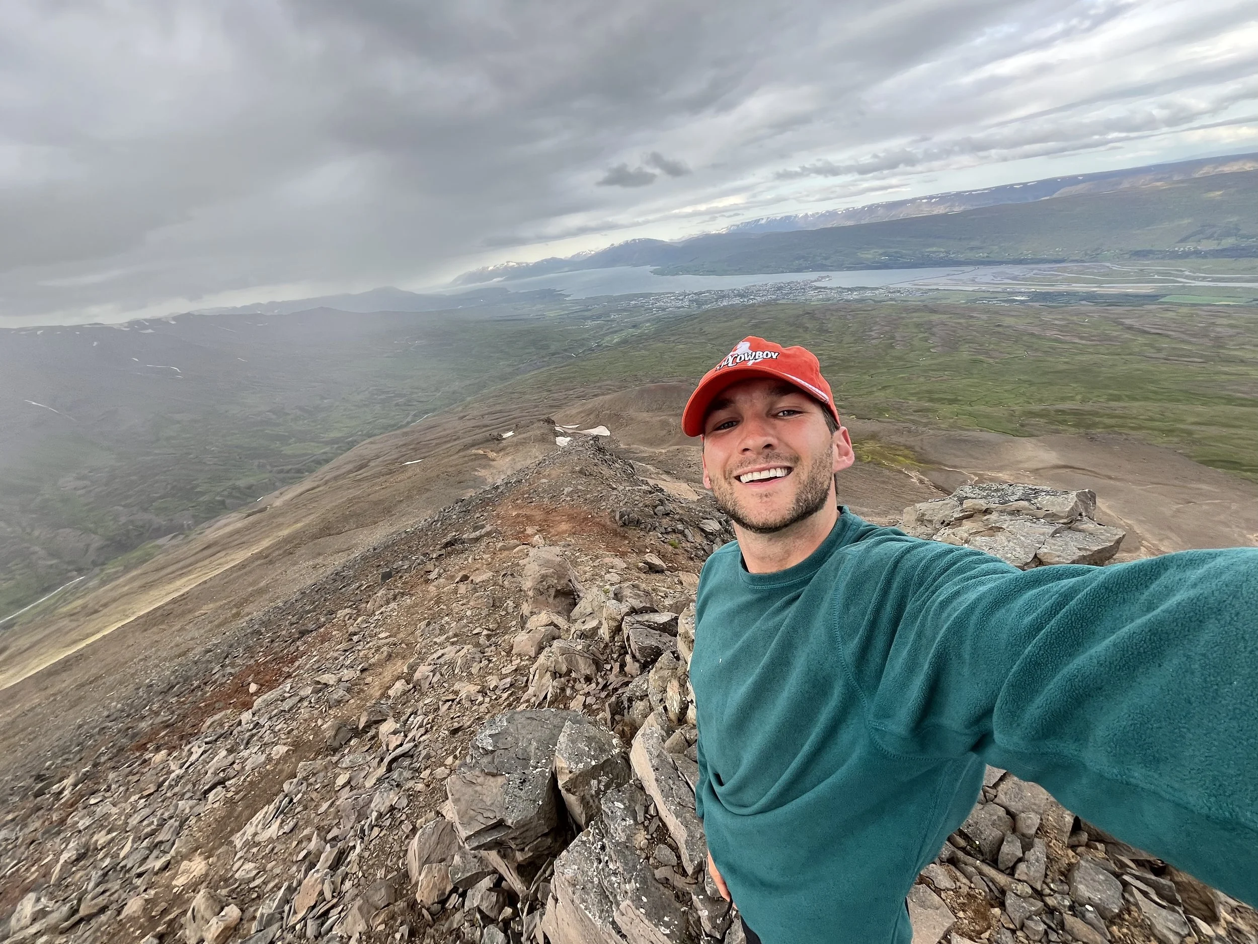 Steve Dierkes, founder of Biophilic, at the top of a peak in Akureyri, Iceland.