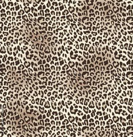 Close-up of a leopard print fabric pattern with black spots on a tan background.
