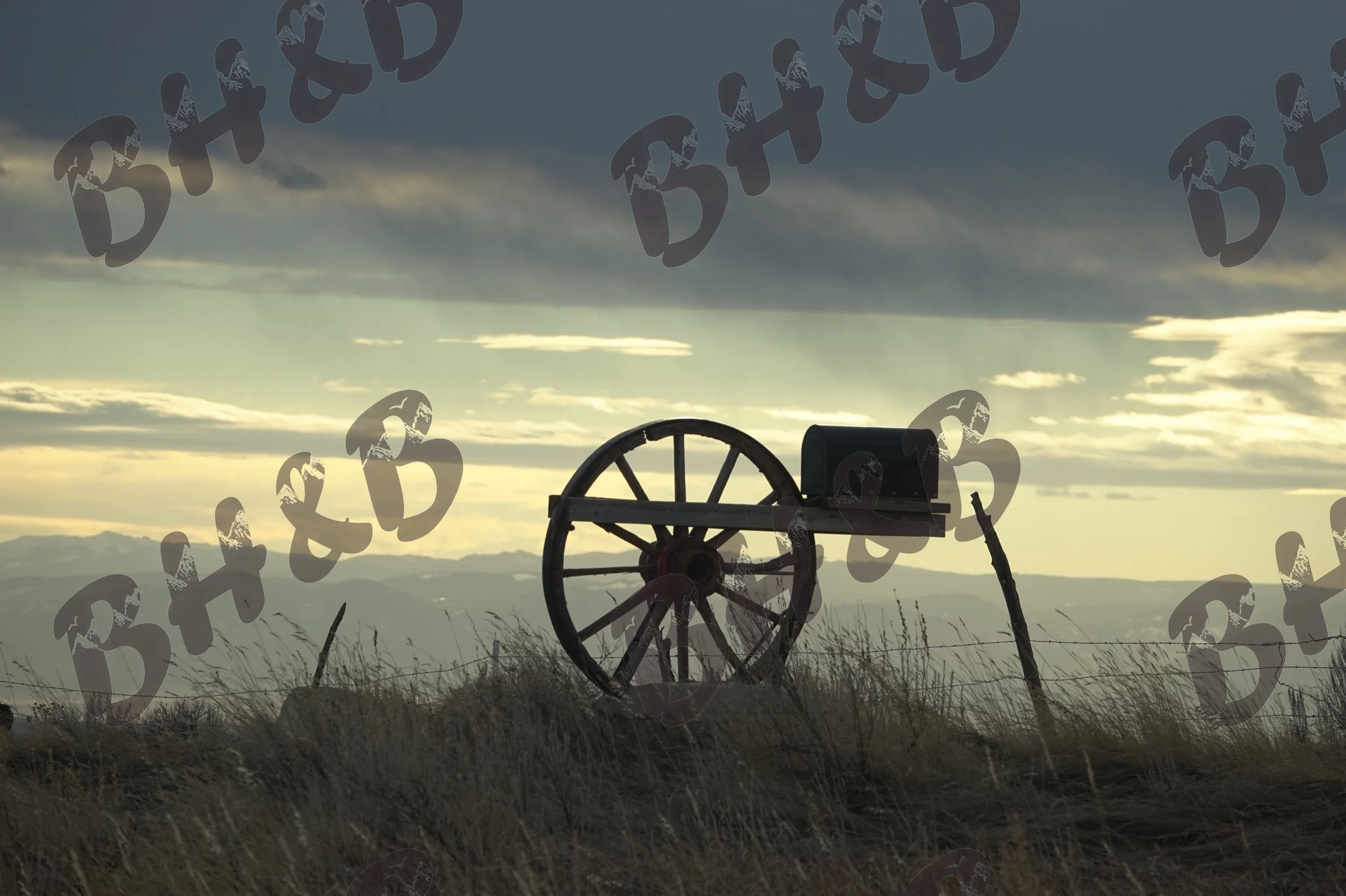 Classic Americana on display with this wagon wheel mailbox in a western sunset