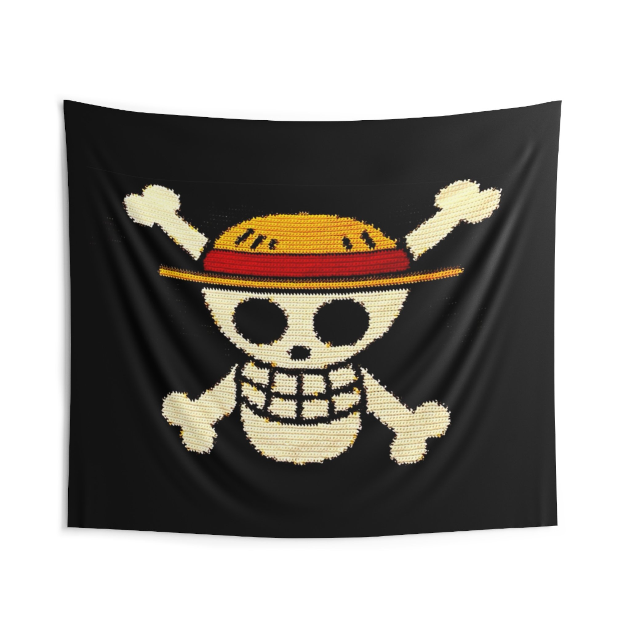 Close-up of a fabric with a skull and crossbones design using crochet. The background is black, and the skull appears in shades of white, yellow, red, and black.