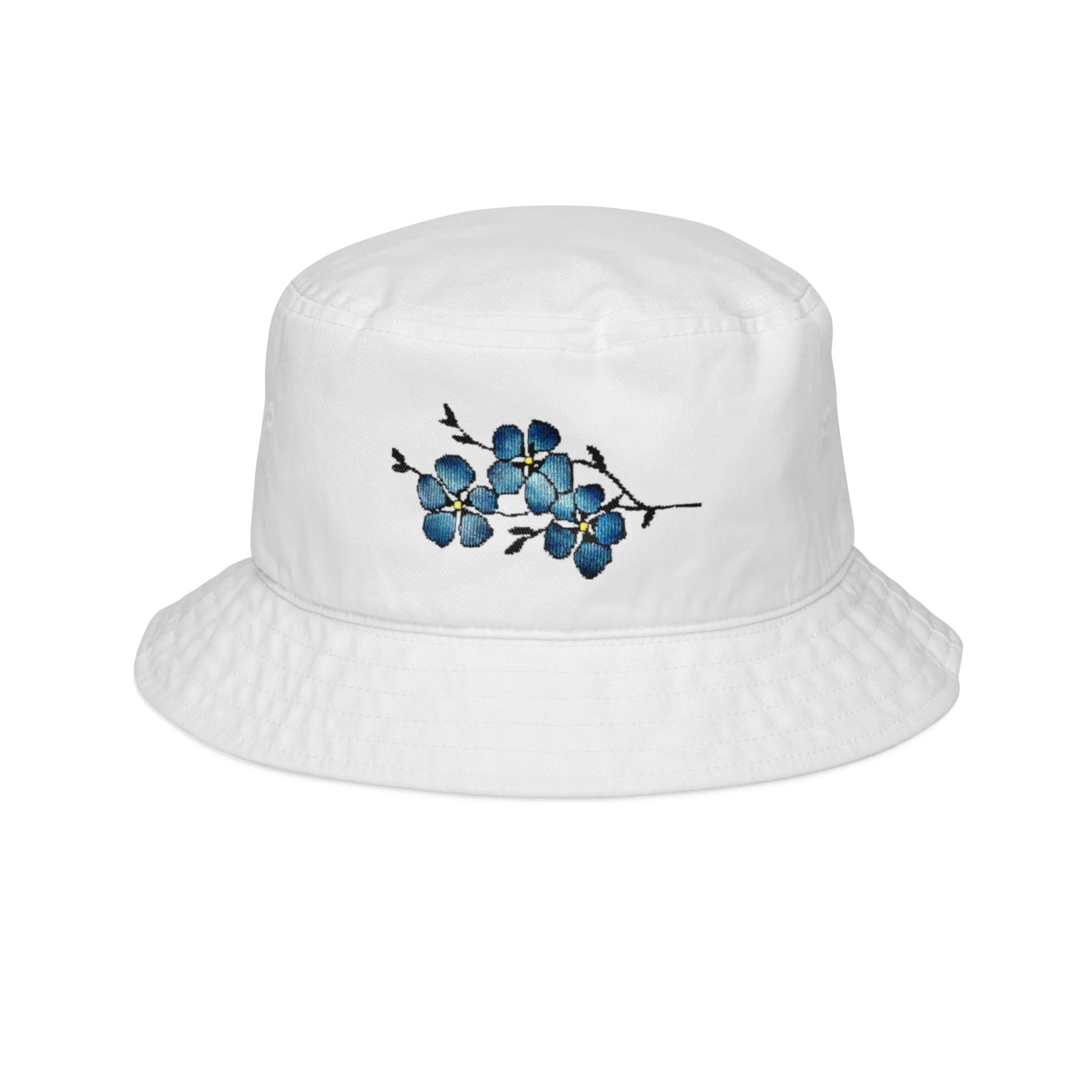 Close-up of a white embroidered bucket hat with a blue flower pattern.