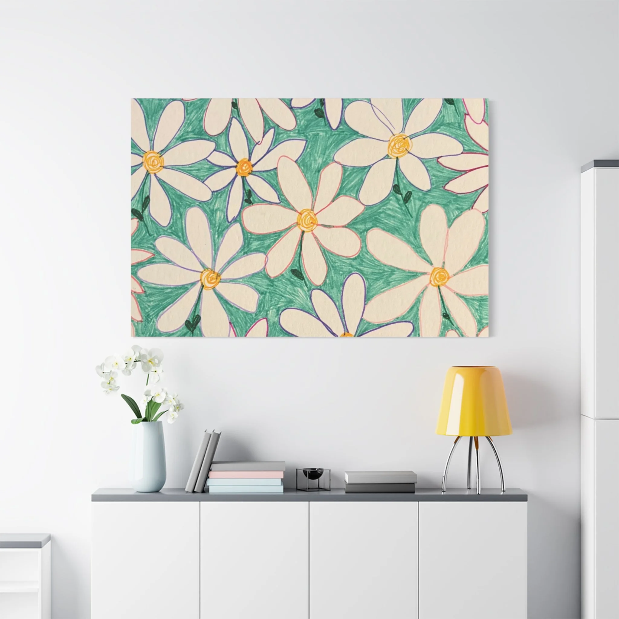 A white shelf against a white wall holding a white vase with white orchids, a stack of books, a small black lantern, and a silver speaker. Above the shelf is a colorful floral artwork with white flowers, green background, and yellow centers.