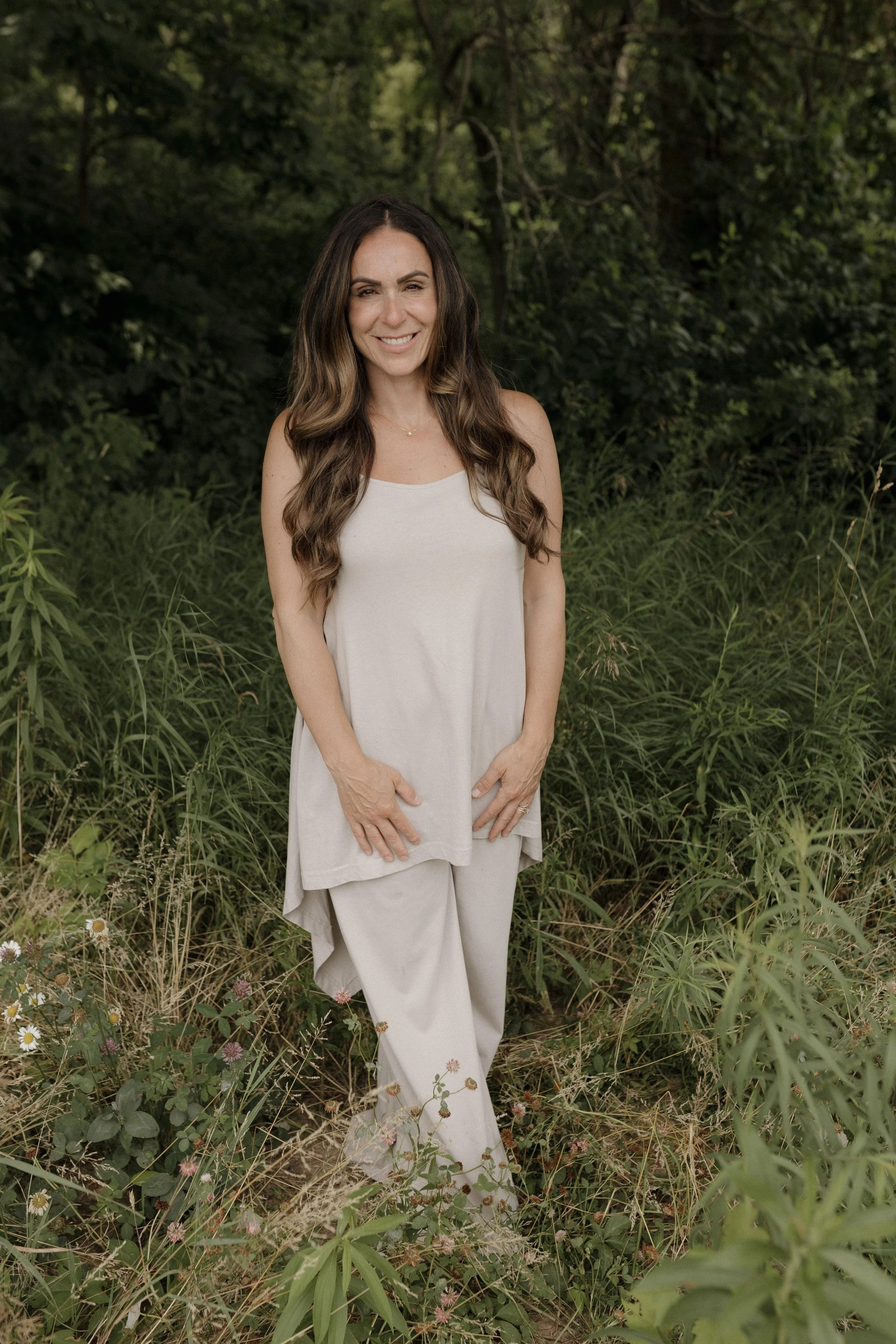 Alyssa M. Corbett standing outdoors in a wooded setting.