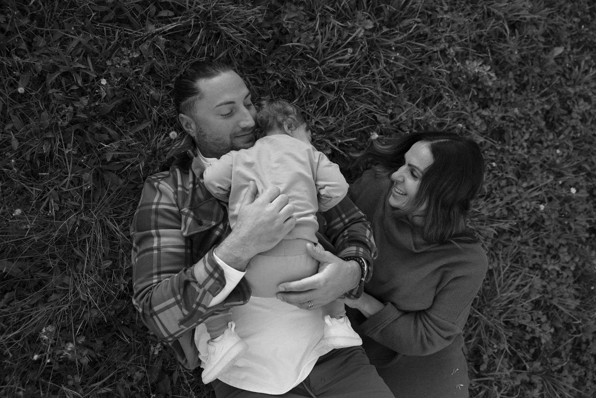 Alyssa M. Corbett with her husband and daughter outdoors.