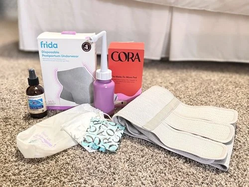 Postpartum hospital bag essentials including disposable underwear, pads, peri bottle, sitz bath spray, and abdominal binder