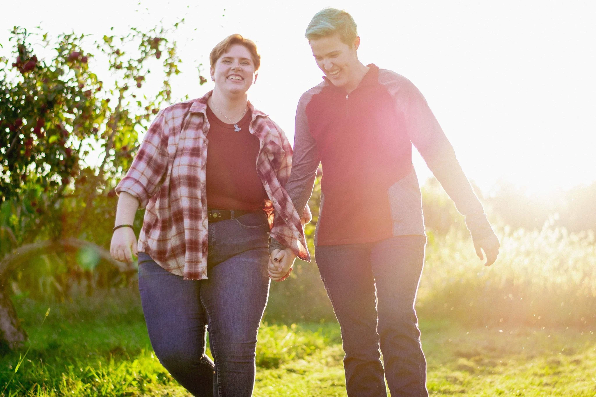 Couple walking through the orchard, couples photographer in Chelsea, MI