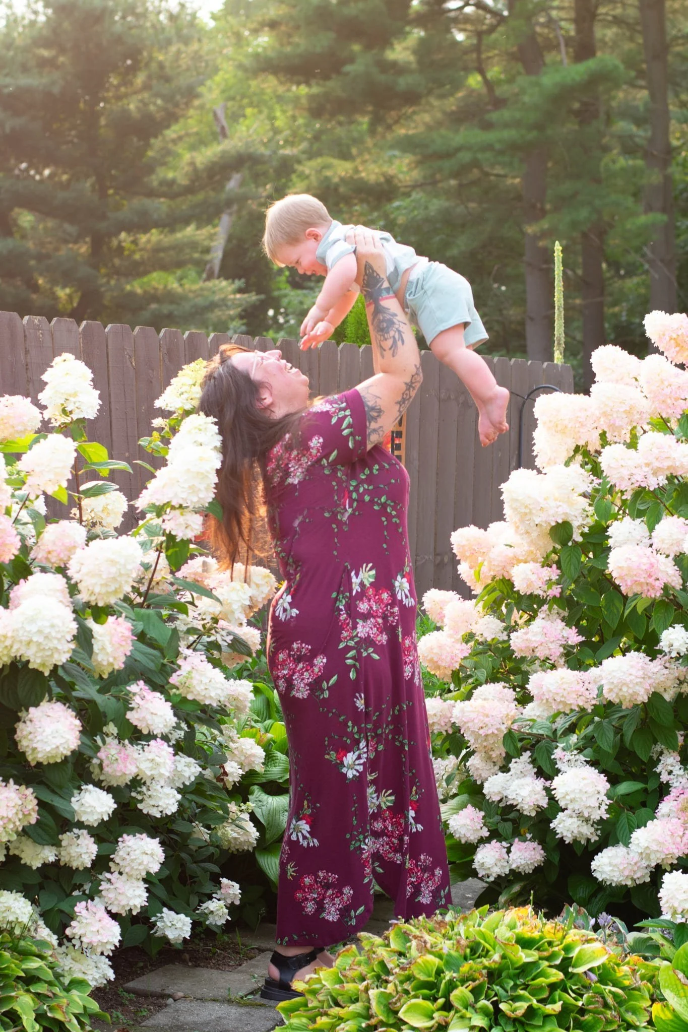Mother lifting her son in a garden, family photography session in Manchester, MI