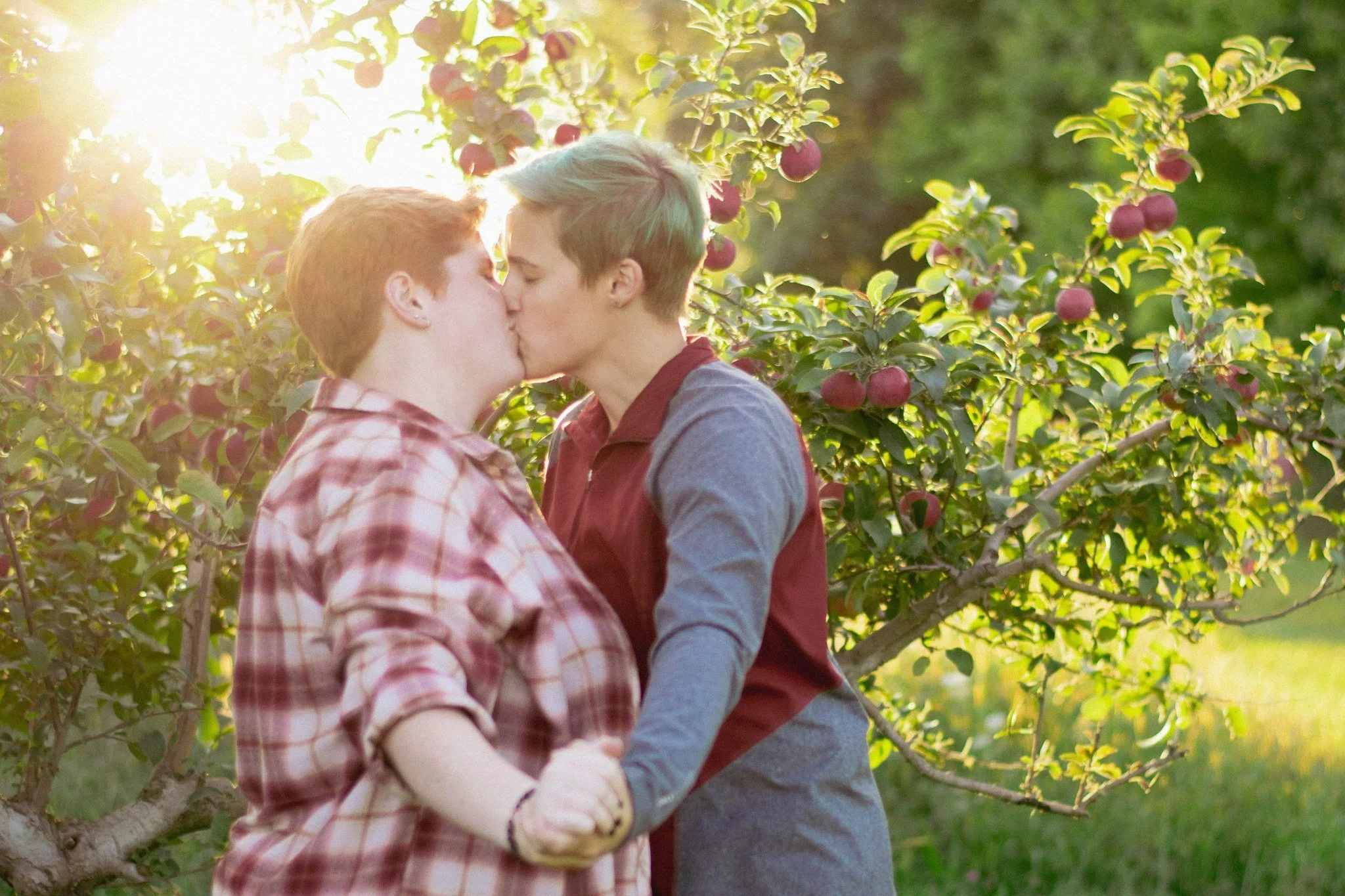 Couple sharing a kiss in the orchard, couples photographer in Dexter, MI