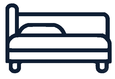Line drawing of a bed with a headboard and mattress.