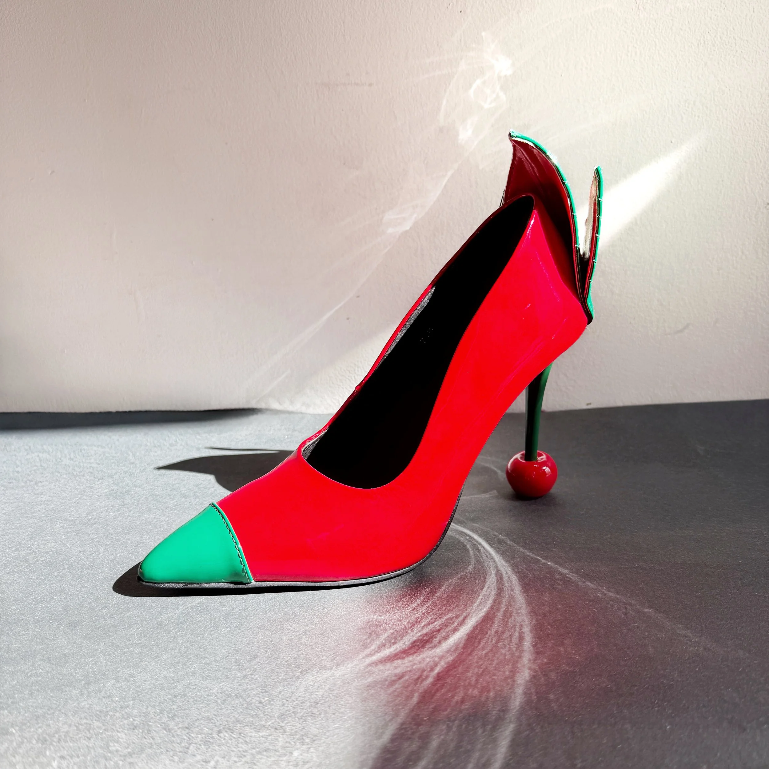 Eat My Cherry -- high heel shoe.
100% Patent leather
100% Leather outsole
100% Leather insole with molded latex soles for comfort.
Vegan leather leaves and back of heel for comfort.

Shipped to you by 2/14/2027